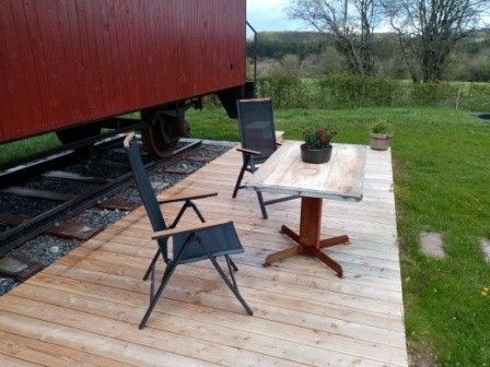 Geniet van de rust op het terras van Le Wagon, een unieke vakantiewoning in Graide, Ardennen, omringd door groene natuur.