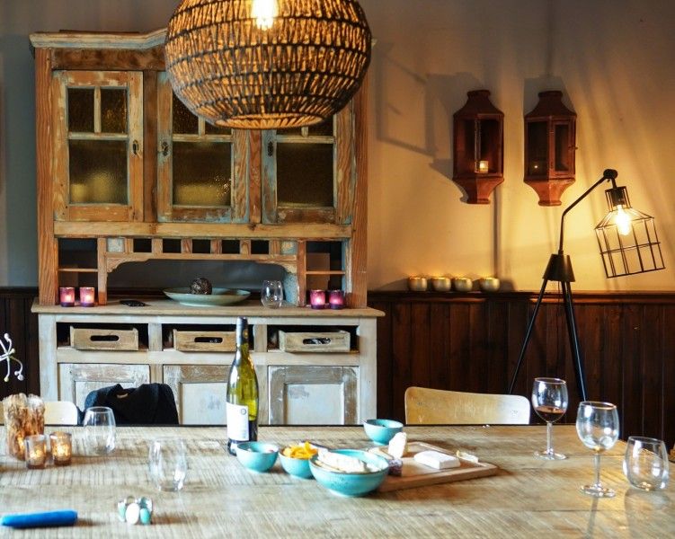 Authentic dining room of Au Foyer, cottage in Durbuy, with rustic cabinet and cozy table.