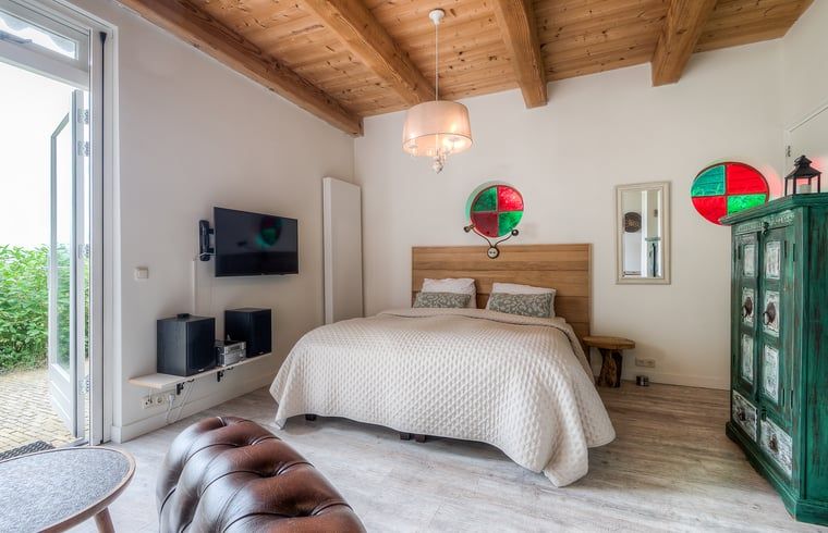 Comfortable bedroom in Cottage in Allingawier with natural light and views of Frisian nature.