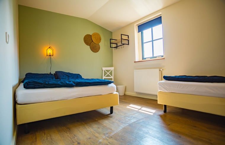 Bedroom in Holiday Home in Beneden-Leeuwen with lots of natural light and rustic details.
