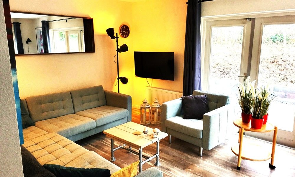 Cozy living room of De Duunhaes in Ouddorp, Zeeland with comfortable sofas and modern furnishings.