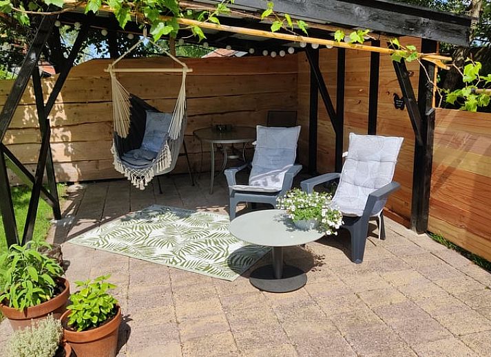 Gezellige veranda bij Vakantiehuisje in Ruigahuizen, omgeven door natuur in Friesland.