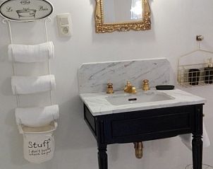 Chique wastafel met gouden kraan in Huis 7, vakantiehuis Ieper, West-Vlaanderen.