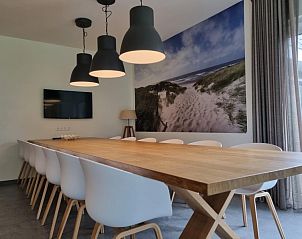 Elegante eetkamer in Villa Duyncoogh, De Koog, Texel, met een lange tafel en wanddecoratie van natuur op de Waddeneilanden.