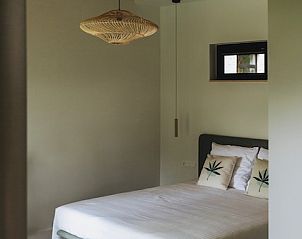 Gezellige slaapkamer in B&B de Zunne, Leisele, West-Vlaanderen, met comfortabel bed en houten details.