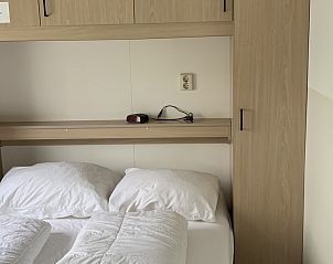 Bedroom in Chalet No. 12, Midsland Noord, Terschelling, with cozy double bed and storage space.