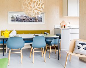 Dining area in Florizand vacation home, Midsland North, Terschelling with modern furniture and cozy atmosphere.