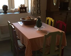 Charming dining room in Holiday Home in Anan, Midi/Pyrenees, with a rustic feel and colorful accents.