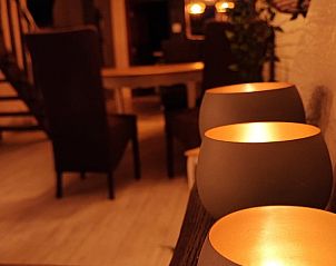 Sfeervolle kaarsverlichting in de eetruimte van vakantiehuis Le Petit Nid de Fort in Trooz, Ardennen.