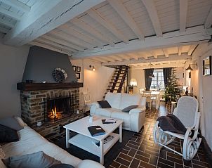 Cozy living room with fireplace in Cottage in Bagimont, vacation home in the Ardennes, Belgium.