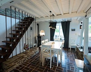 Stylish dining area with stairs in Cottage in Bagimont, vacation home in the beautiful Ardennes, Belgium.