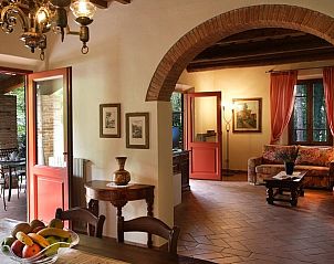 Villa Daniela's sfeervolle binnenruimte in Montaione, Toscane, Itali, biedt een uitnodigende woonkamer en toegang tot het terras.