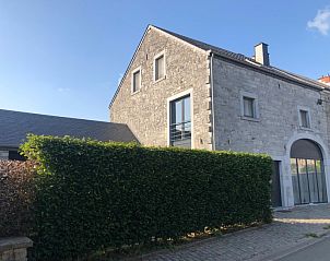 Les Hirondelles de Durbuy vacation home in the Ardennes, Belgium with stone facade and green hedge.