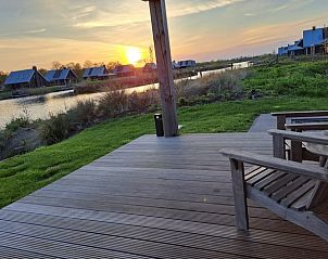 Terras van Huisje in Sint Nicolaasga met uitzicht op de zonsondergang bij de Langweerderwielen.