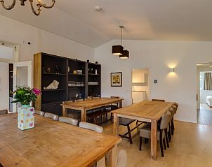 Eetkamer in La Cabane parterre, vakantiehuis aan zee, Belgische kust, Belgi met houten tafels en moderne stoelen.