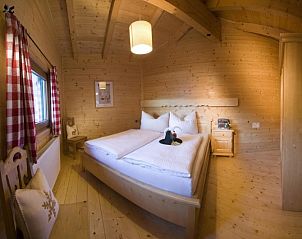 Warm and inviting bedroom in Chalet Hainzenberg, located in picturesque Zell am Ziller, Tyrol, ideal for a mountain vacation.