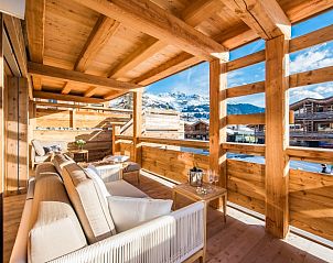 Challet Teaga Kitzbuhel biedt een uitnodigende veranda met uitzicht op de bergen in het schilderachtige Kitzbhel, Tirol.