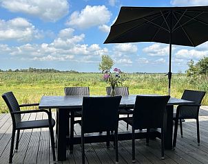 Dining table on terrace of Cottage in Gongahuizen, cottage in Pikmeer, Frisian lakes, with beautiful view of nature.