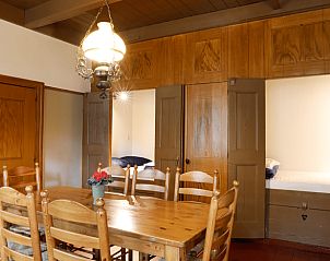 Dining room in vacation home in Orvelte, Central Drenthe, with wooden furniture and mood lighting.