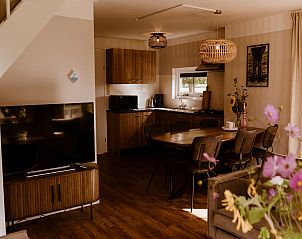 Open kitchen and dining area in Holiday Home Comfortable 8 in Bant, Flevoland.