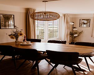 Dining table in Holiday home Comfortable 8 in Bant, Flevoland with stylish lighting.