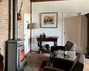 Cozy sitting area with fireplace in vacation home Hoog Soeren, Veluwe.