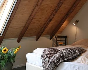 Slaapkamer onder houten dak in Hoeve Springendal vakantiehuis, Ootmarsum, Overijssel.