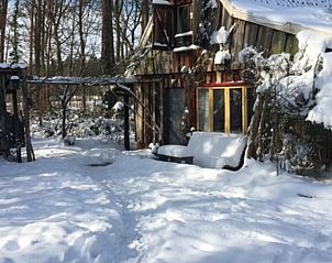 Sneeuw bedekt het vakantiehuisje in Boekelo, Enschede, een winterwonderland in Twente voor een gezellig verblijf in Overijssel.