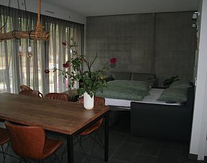 Gezellige binnenruimte van Vakantiehuisje in Hellendoorn, Overijssel, met een moderne eetkamer en comfortabele zithoek.