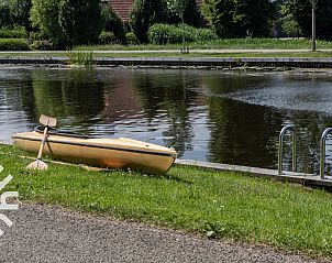 Slaapkamer met houten interieur in vakantiehuis OV006 in Scheerwolde, Noordwest Overijssel, met twee bedden.