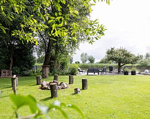 Buitenkant van Vakantiehuisje in Wetering, Overijssel met kano's en groene omgeving.