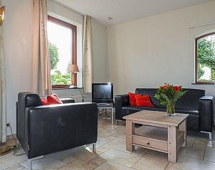 Bright living room with large windows in VZ524 Vakantiewoning Kattendijke, Zeeland.