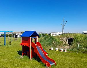 Play facilities for children at Holiday home in BORSSELE, Borssele, Zeeland, with slide and swings in a safe environment.