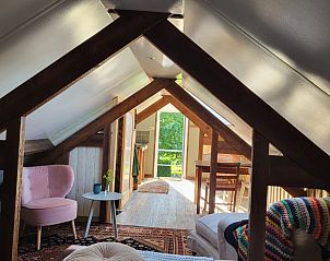 Gezellige zolderruimte in Vakantiehuisje in Rilland, Zuid-Beveland, met houten balken en uitzicht op de groene omgeving van Zeeland.