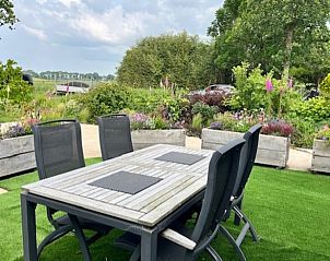 Enjoy the terrace at Holiday Home in Noorden, Green Heart, South Holland, surrounded by lush nature and rustic charm.